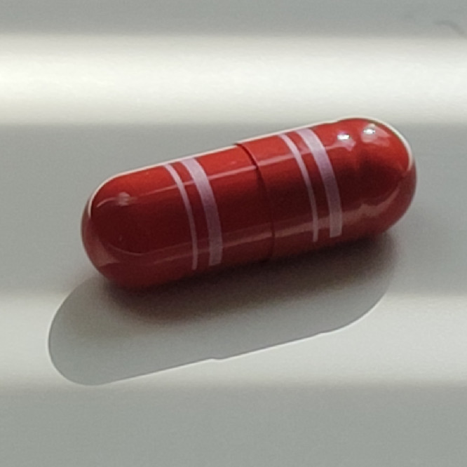 dark red capsule with barcode
