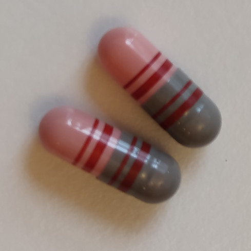 red/gray capsule with barcode