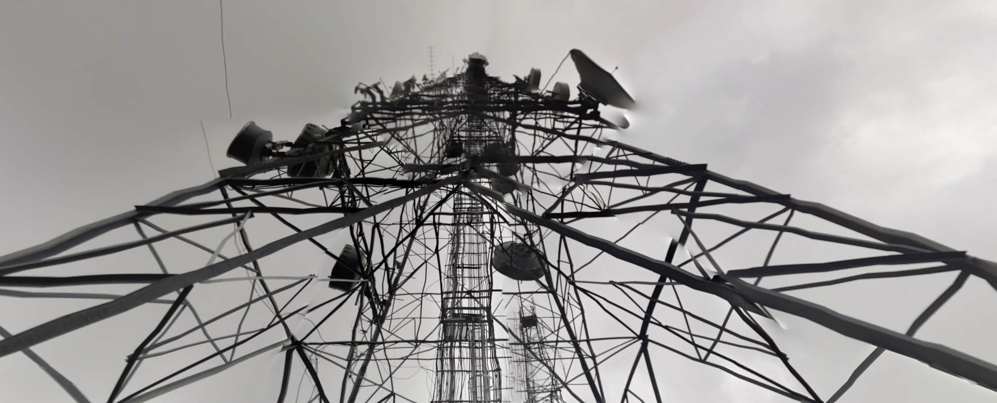 photo of an antenna tower, metal lattice, but the image is somewhat chopped up and the pars slightly displaced